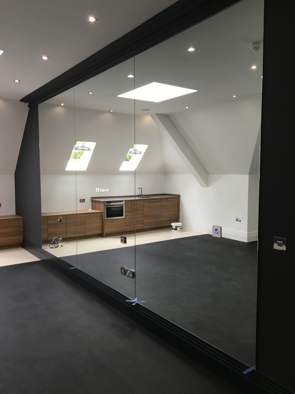 Frameless glass partition in loft conversion by Tufnell Park glaziers