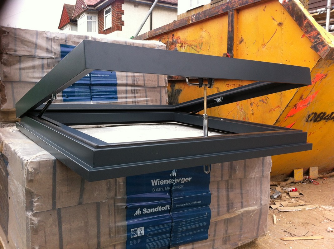 Opening flat roof skylight in anthracite grey installed in Tufnell Park